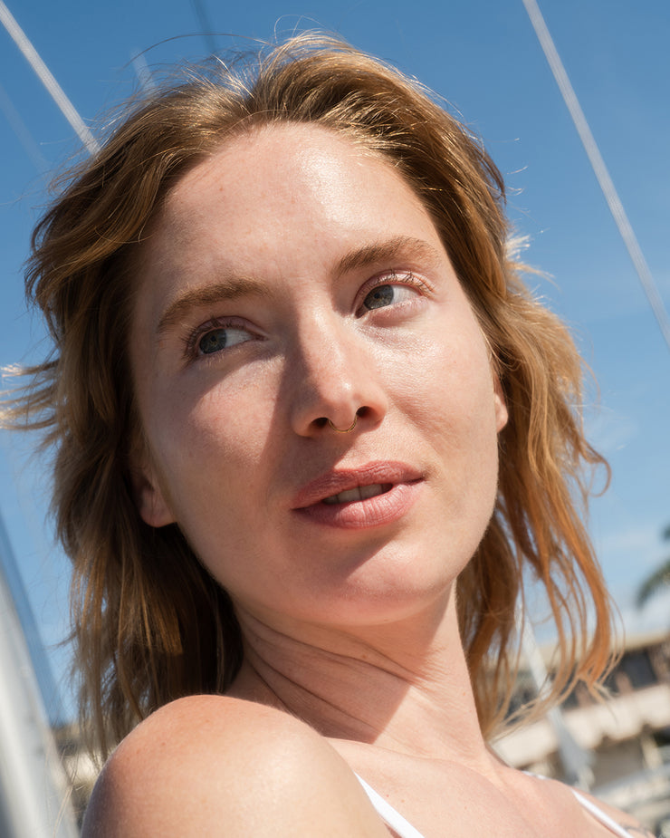 Woman with moisturized skin with blue sky background