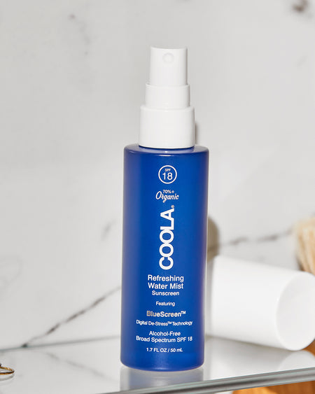 COOLA Refreshing Water Mist sitting on bathroom shelf