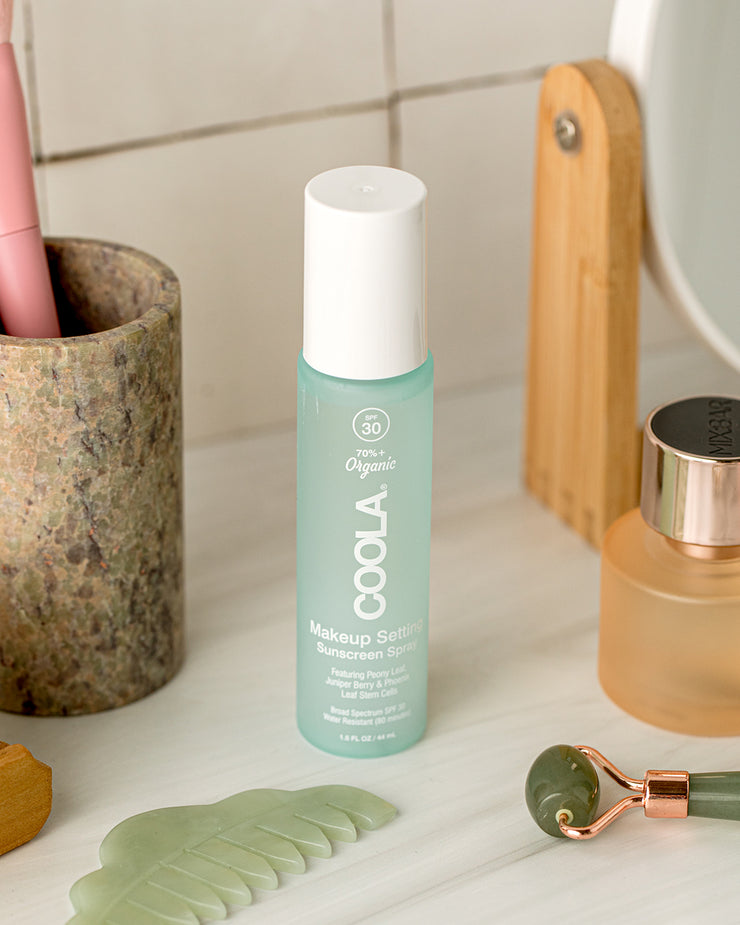 COOLA Makeup Setting Spray sitting on bathroom shelf