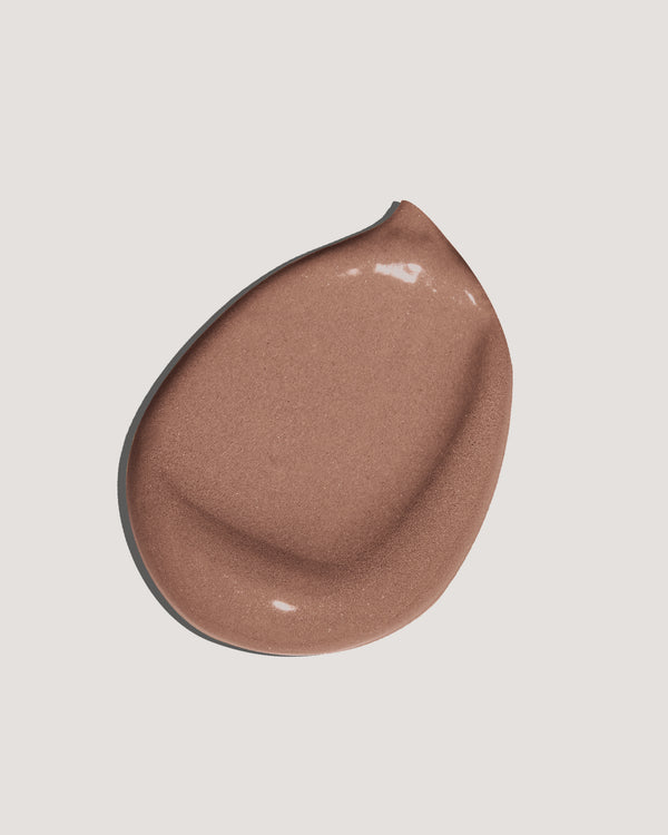 Light brown formula swatch of tinted moisturizer sunscreen on neutral background