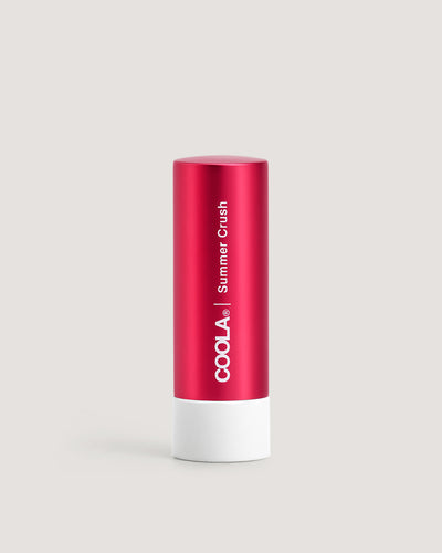 A red tube of COOLA Liplux Tinted Lip Balm with SPF 30, labeled 'Summer Crush'.
