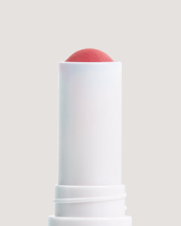 Close-up of COOLA Summer Crush formula against beige background.