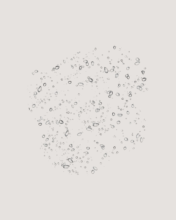 COOLA Rewakening Rosewater Mist formula on beige background.