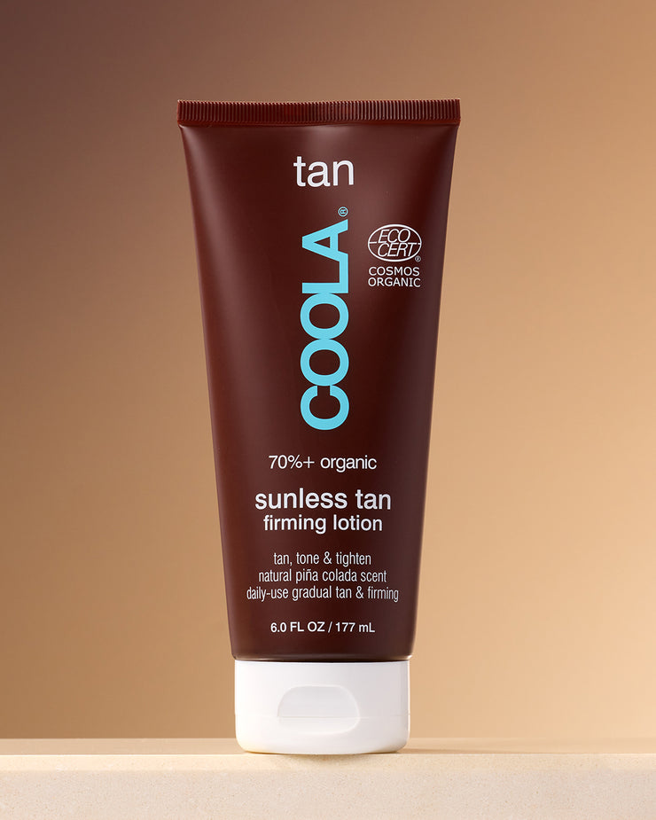 Sunless Tan Firming Lotion sitting on counter against tan background.