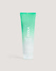 Coola Pacific Polish Exfoliator with a green gradient sitting against a neutral background