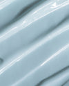 Close-up of COOLA Refreshing Water Cream formula with blue tint