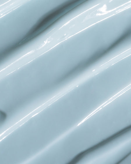 Close-up of COOLA Refreshing Water Cream formula with blue tint