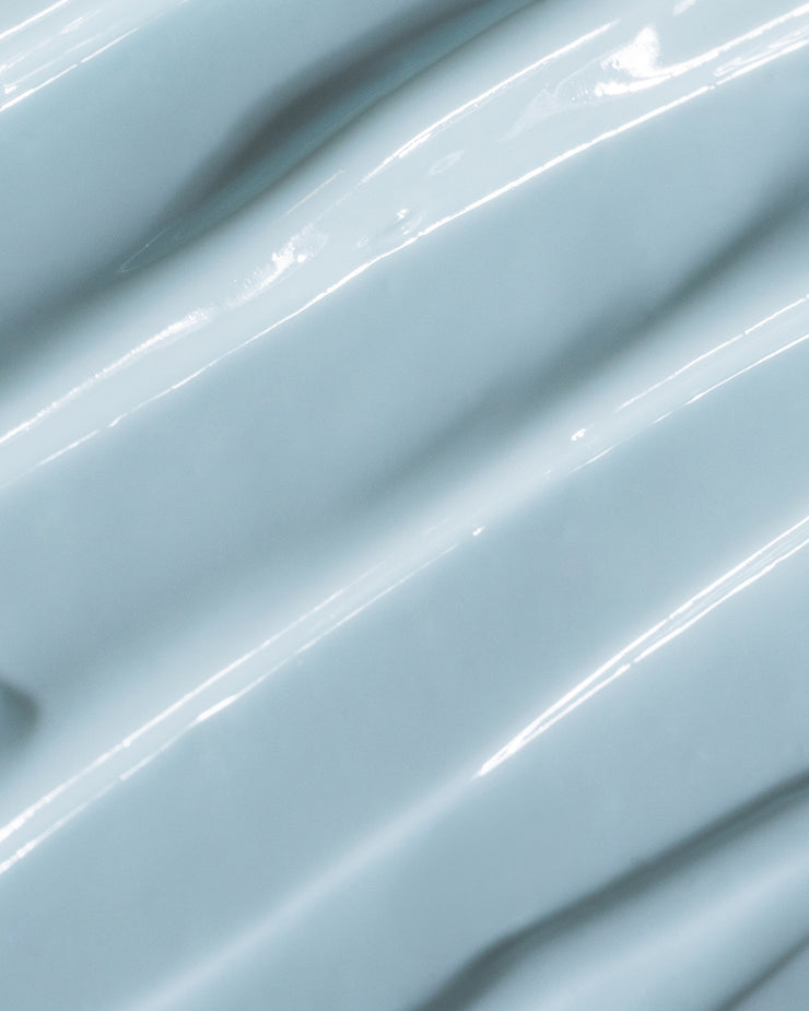 Close-up of COOLA Refreshing Water Cream formula with blue tint