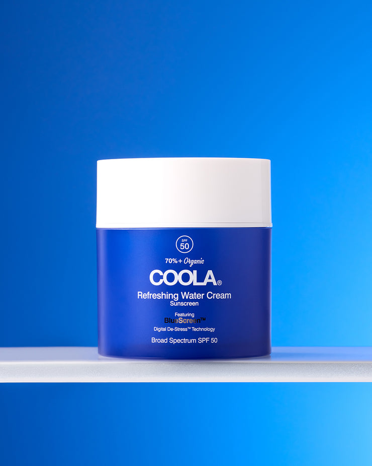 COOLA Refreshing Water Cream sitting on shelf against blue background