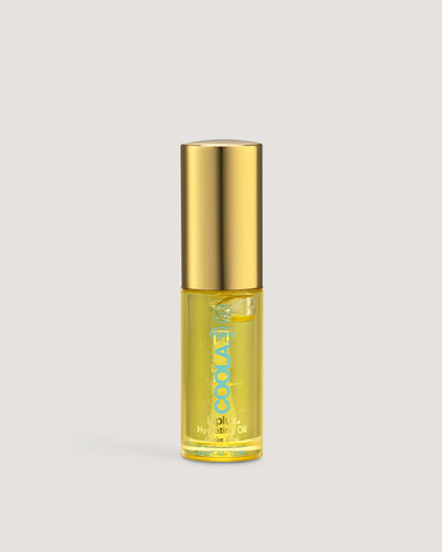 A small, clear glass bottle with a gold lid containing yellow liquid, labeled as Liplux Hydrating Lip Oil.