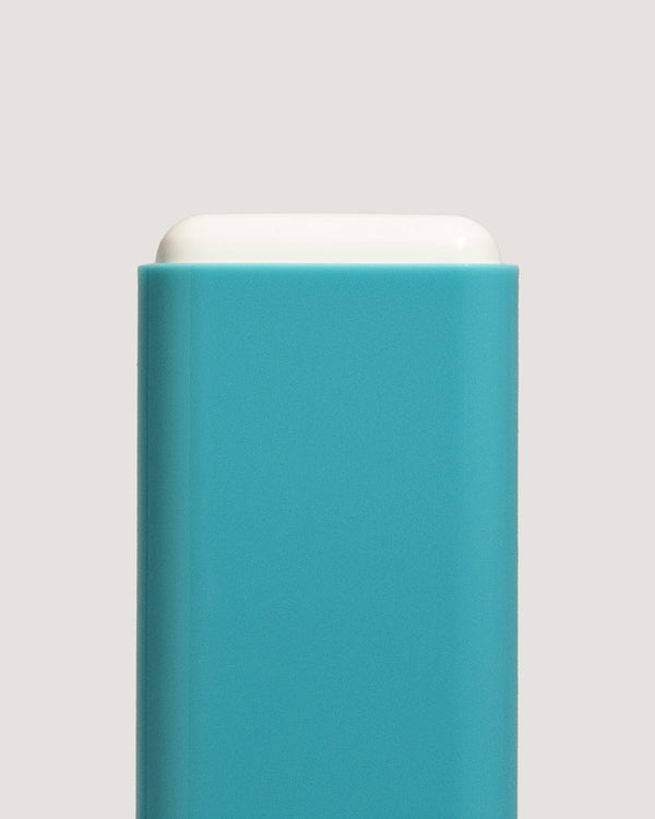 COOLA Mineral Sunscreen Stick uncapped showing formula with teal body