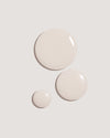 COOLA Sun Silk Drops Sunscreen SPF 30 formula drops against neutral background