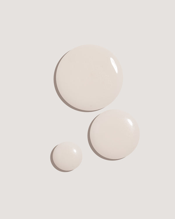COOLA Sun Silk Drops Sunscreen SPF 30 formula drops against neutral background