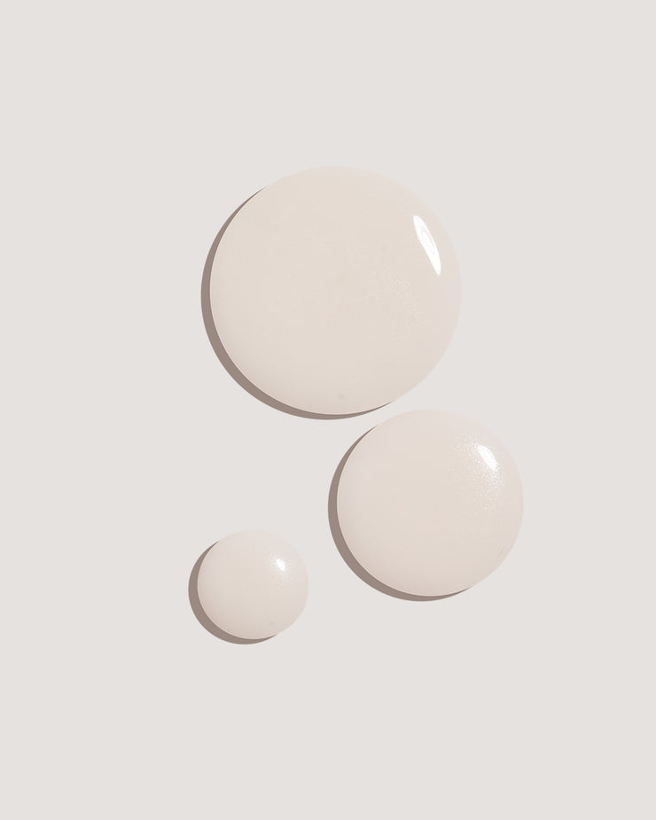 COOLA Sun Silk Drops Sunscreen SPF 30 formula drops against neutral background