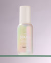 Bottle of COOLA Clear Skin Oil-Free Moisturizer Zinc Oxide Sunscreen sitting on glass shelf with white background
