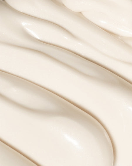 Close-up of COOLA Dew Good Illuminating Body Melt Lotion SPF 40 formula