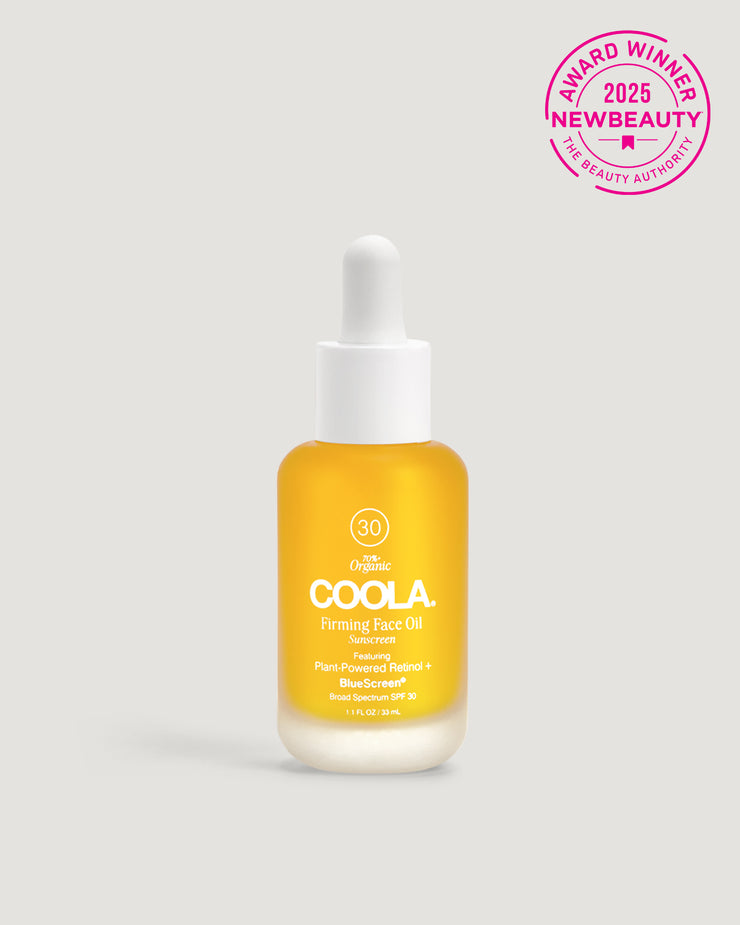 A bottle of COOLA Firming Face Oil with a dropper, highlighted by a '2025 NewBeauty Award Winner' badge.
