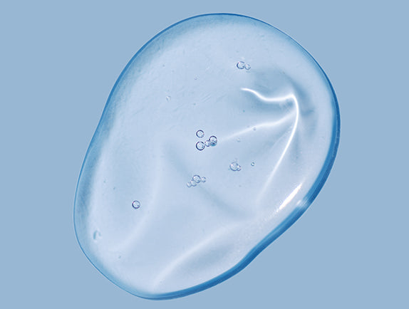 Close-up of glycerin on light blue surface