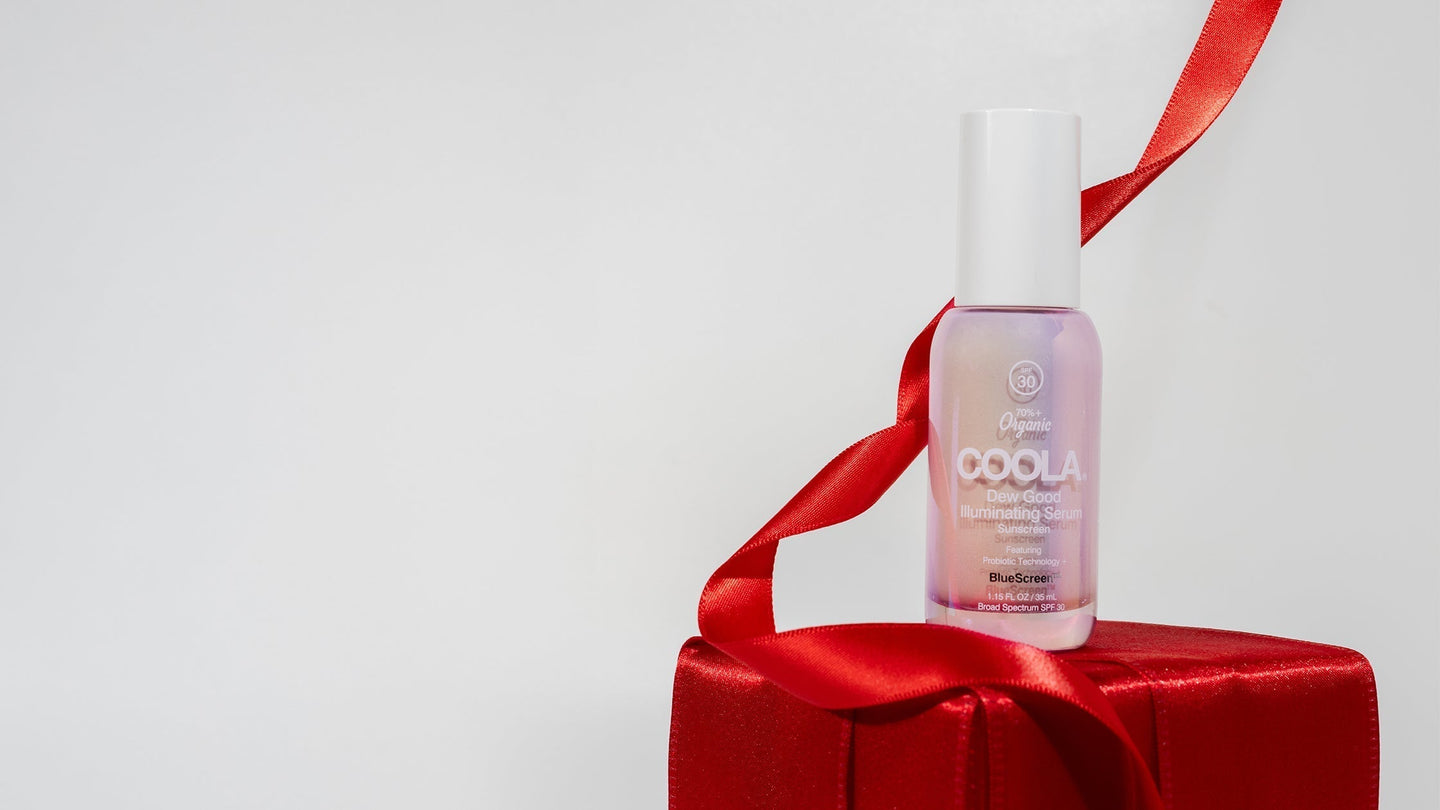 COOLA Dew Good Illuminating Serum on a red present