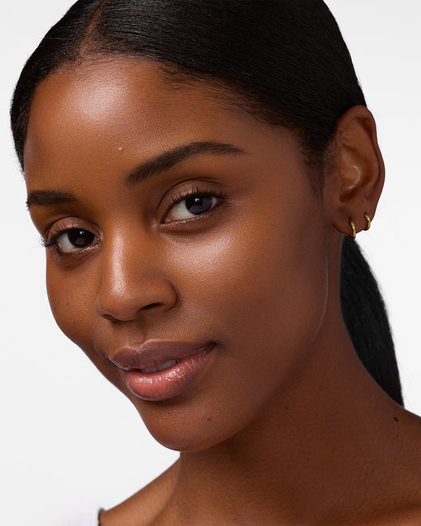 Close-up of a woman with a neutral expression on a white background