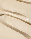 Dew Good Body Melt Lotion with a smooth creamy texture spread in soft swirls for a luxurious organic skincare experience
