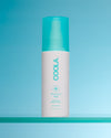 Coola Recovery Mist bottle on a blue background