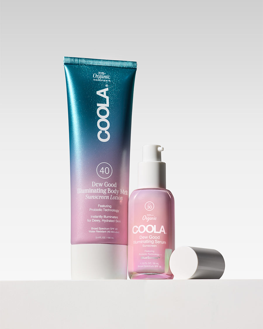 Blue and pink COOLA sunscreen containers with a pump bottle and silver cap arranged against a clean light background”】【