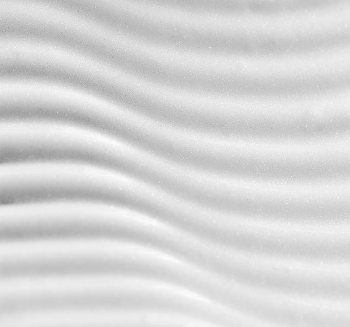 Soft grayscale waves create an abstract rippled texture with gentle highlights and shadows