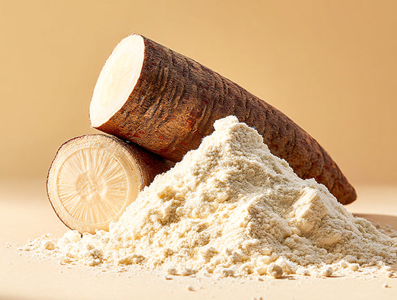 Raw cassava root and its powder on a beige background