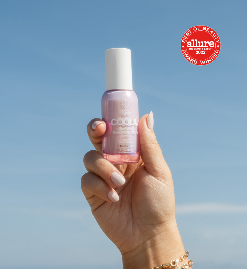 Hand holding pink sunscreen bottle with Allure Best of Beauty badge featured